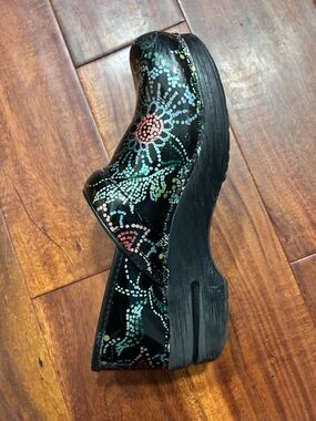 Dansko Black Leather Floral Dot Clogs